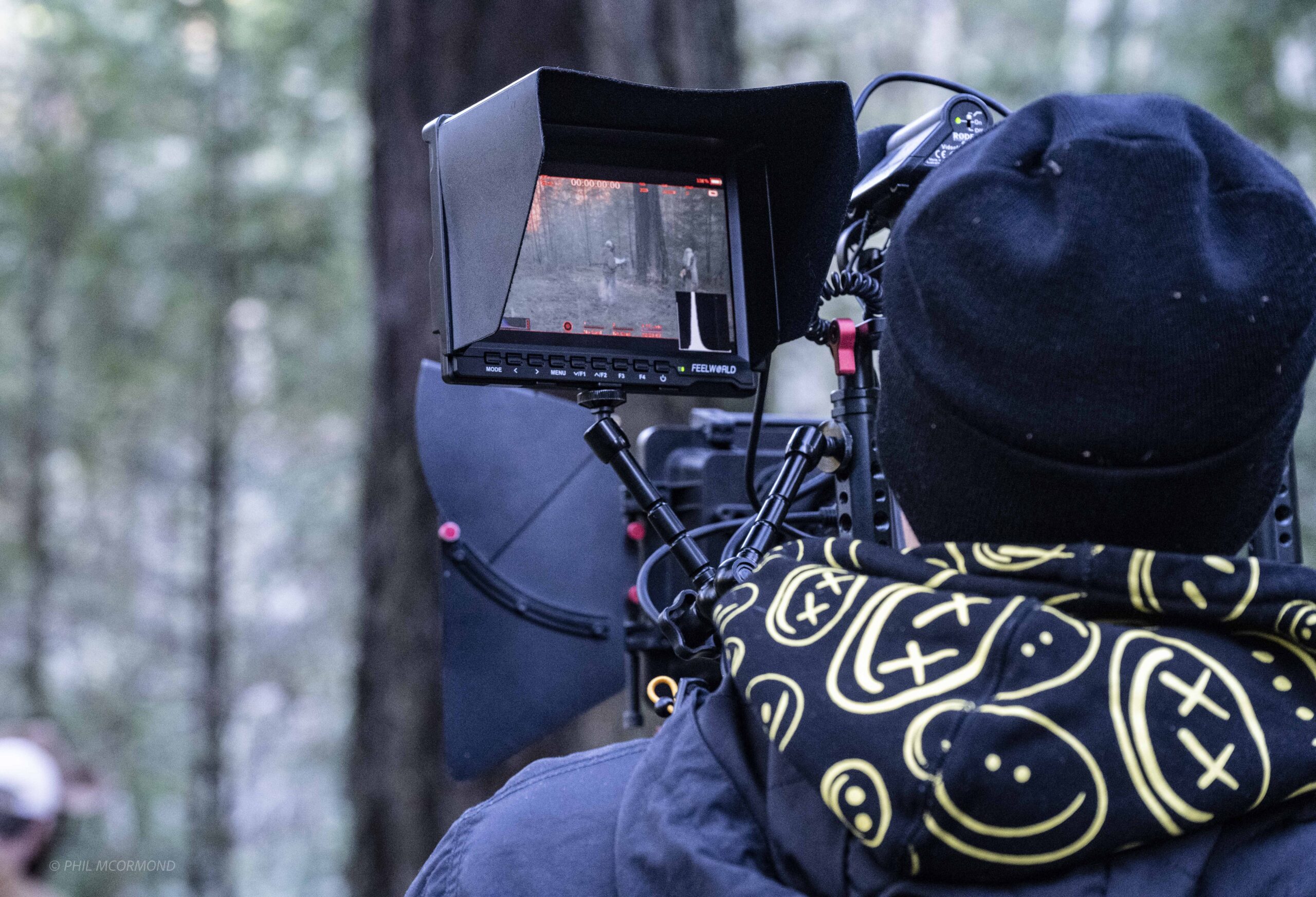 Cinematographer operating camera in the forest